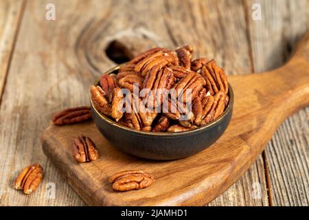 Pecan walnuts on wooden background. close up Stock Photo