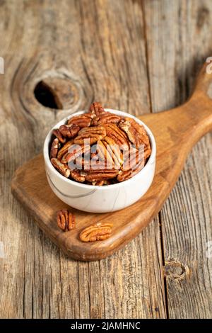 Pecan walnuts on wooden background. close up Stock Photo