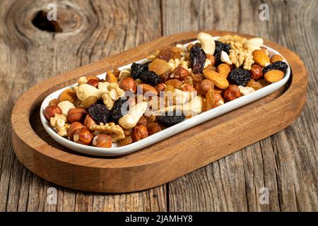 Mixed nuts on wooden background. Nuts, walnuts, raisins and cashews. close up Stock Photo
