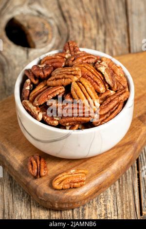 Pecan walnuts on wooden background. close up Stock Photo