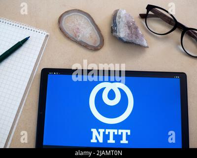 In this photo illustration, Nippon Telegraph and Telephone Corporation (NTT Group) logo seen displayed on a tablet. Stock Photo