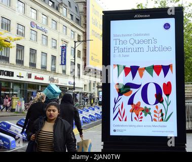Manchester, UK, 31st May, 2022. People walk past an electronic sign advertising Jubilee events in Manchester, UK. Queen's Platinum Jubilee preparations, in Manchester, England, United Kingdom. In 2022, Her Majesty The Queen will become the first British monarch to celebrate a Platinum Jubilee after 70 years of service. The Platinum Jubilee Central Weekend takes place from 2nd to 5th June. Friday 3rd June is an extra Bank Holiday, resulting in a four-day bank holiday weekend. Credit: Terry Waller/Ģ����ý Live News Stock Photo
