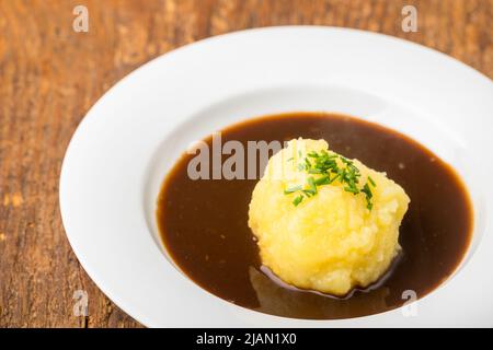 bavarian dumpling in a plate with sauce Stock Photo
