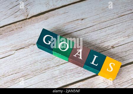 Goal word on colorful wooden cubes on wooden desk. Business concept. Stock Photo