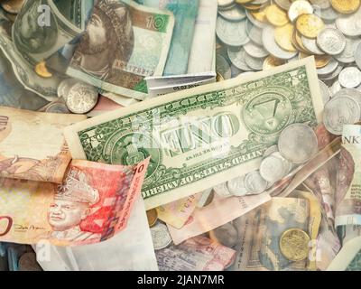 One American dollar bill among many world currencies, cash, money exchange business, finance, economy, nobody. Investment, currency exchanging, bankin Stock Photo