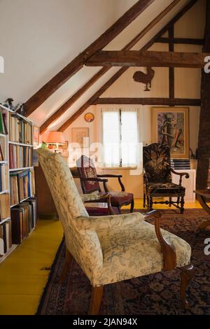 Upholstered chairs and furnishings in upstairs living room inside old circa 1810 Canadiana cottage style home. Stock Photo