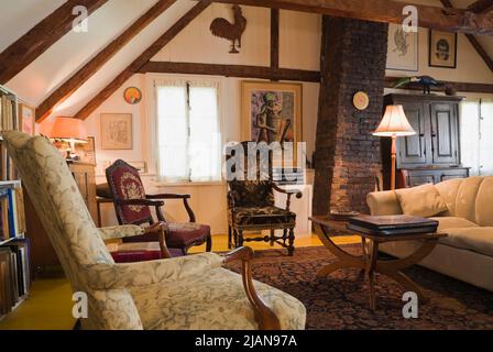 Upholstered chairs, sofa and furnishings in upstairs living room inside old circa 1810 Canadiana cottage style home. Stock Photo