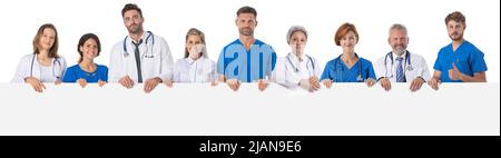 Group of doctors presenting empty banner. Isolated on white background, copy space for text Stock Photo