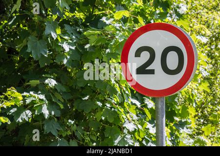 Road sign indicating speed limit of 20 MPH or 20 km per hour. Even number rules of the road follow the rules metaphor road signs UK speed zone Stock Photo Alamy