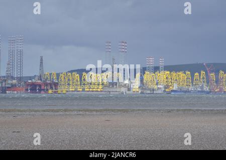 CROMARTY FIRTH, SCOTLAND, UK - 25 May 2022 - Oil rigs and platforms for offshore wind turbines at the yard in Nigg in the Cromarty Firth Stock Photo