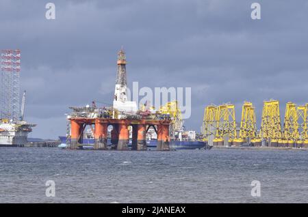 CROMARTY FIRTH, SCOTLAND, UK - 25 May 2022 - Oil rigs and platforms for offshore wind turbines at the yard in Nigg in the Cromarty Firth Stock Photo