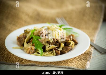Homemade boiled noodles with meat and eggplant in a plate Stock Photo