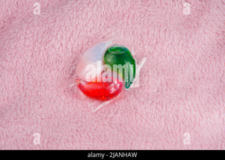 Multicolor gel capsule for washing powder on fabric textile Stock Photo