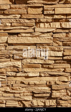 Rock stone brick tile wall has a detailed background texture sepia cream brown color stacked in layers, you can use this image as a background image Stock Photo