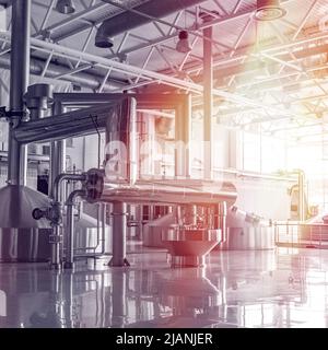 Brewery tank with beer fermentation. Interior of modern brewer manufacture. Factory equipment for beer production. Shiny steel vats. Metallic Stock Photo