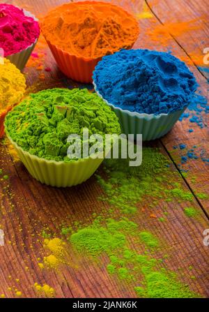 Holi color powder. Organic Gulal colours in bowl for Holi festival, Hindu tradition festive. Blue, pink, magenta, orange, yellow holi dry paints on Stock Photo