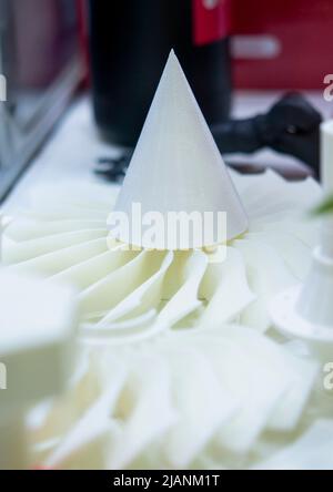 White object 3D printed from plastic close-up. New 3D printing technology. Concept modern new progressive additive technology. 3D model created by additive 3d printing high-precision technologies. Stock Photo