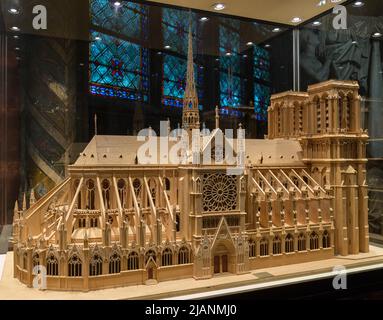 Paris, France, March 27, 2017: Wooden model of Notre Dame de Paris under a glass dome. Notre Dame construction began in the year 1163 and was Stock Photo