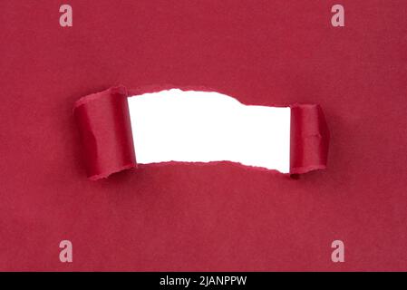 Hole in paper red background torn damaged for design Stock Photo