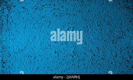 Close-up shot of turquoise textured surface. Worn light blue perforated wall background. Stock Photo