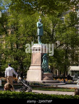 Tourists admiring the statue of famous Finnish poet in Helsinki Stock Photo