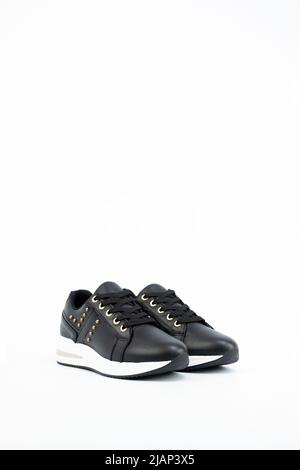 Pair of black with colours Casual shoes isolated on White. Casual Women Sneakers Side View. Lady Black Casual Sneakers. Stock Photo