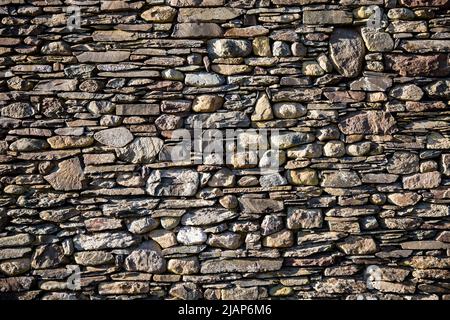 Full frame texture background of a tall and wide dry stone wall typical to Yorkshire, Lancashire and Cumbria in the UK with copy space Stock Photo