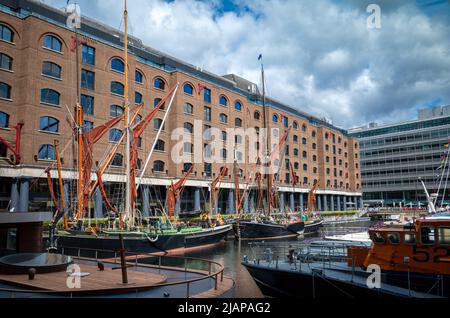 Traditional Thames Sailing Barges lie moored within the preserved St Katharine Docks in London. Stock Photo