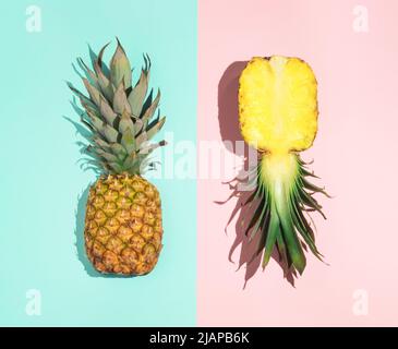 Colorful pattern of pineapple on pastel blue and pink background. Top view. Minimal tropical fruit summer concept. Stock Photo