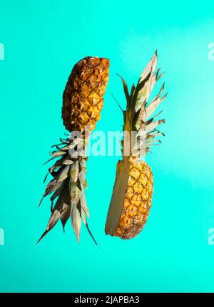 Sliced juicy pineapple on pastel background. Minimal fruit concept. Modern food composition. Stock Photo
