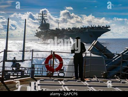 Seaman Marcus White, from San Diego, stands watch as aft lookout aboard the Ticonderoga-class guided-missile cruiser USS Chancellorsville (CG 62) during a replenishment-at-sea with the Nimitz-class aircraft carrier USS Ronald Reagan (CVN 76). Chancellorsville is forward-deployed to the U.S. 7th Fleet area of operations in support of security and stability in the Indo-Pacific region. PHILIPPINE SEA (June 2019)  Optimised version of a U.S. Navy photo. Credit US Navy/J.Harris Stock Photo