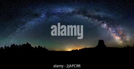 Panoramic night sky. The Milky Way arching over Devils Tower. Devils Tower National Monument. Wyoming, USA.  An optimised version of a US National Park Service. Photo credit: NPS/D.Joyce Stock Photo