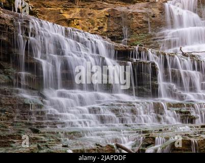 Albion Falls. Albion Falls is a 19 m classical/cascade waterfall flowing down the Niagara Escarpment in Red Hill Valley, in Hamilton, Ontario, Canada. With cascade falls the downpour is staggered into a series of steps causing water to 'cascade'. The top of the falls are located on Mountain Brow Blvd Stock Photo