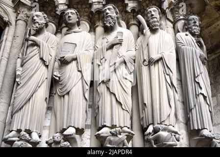 Jamb Statues, Chartres Cathedral, about 80 km southwest of Paris, France. These jamb statues are on the right side of the central portal of the south porch. From left to right: St. Paul holding the sword that killed him, standing over the emperor Nero; St. John the Divine holding a book; St. James the Greater over Herod Agrippa; St. James the Lesser, holding the club with which he was beaten to death; St. Bartholomew. St. James the Greater carries a pilgrim's pouch with scallop shells, a symbol worn by pilgrims who journeyed to his shrine at Santiago de Compostela. Stock Photo