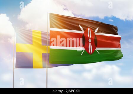 Sunny blue sky and flags of kenya and sweden Stock Photo