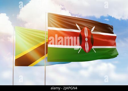 Sunny blue sky and flags of kenya and tanzania Stock Photo