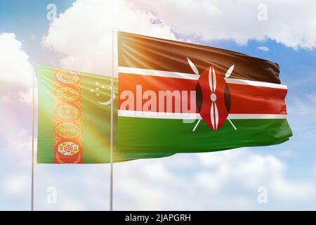 Sunny blue sky and flags of kenya and turkmenistan Stock Photo