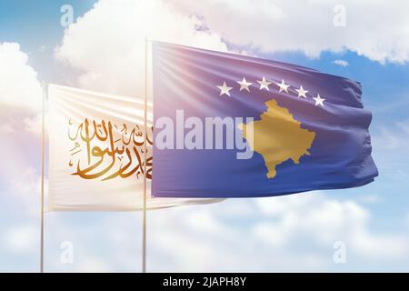 Sunny blue sky and flags of kosovo and afghanistan Stock Photo