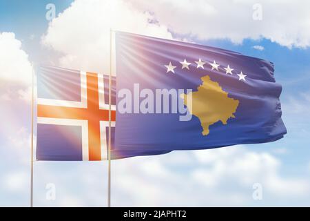 Sunny blue sky and flags of kosovo and iceland Stock Photo