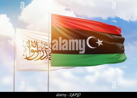 Sunny blue sky and flags of libya and afghanistan Stock Photo