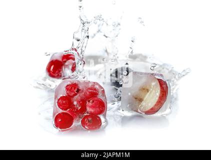 Fresh berries frozen in ice with splash of water on white background Stock Photo