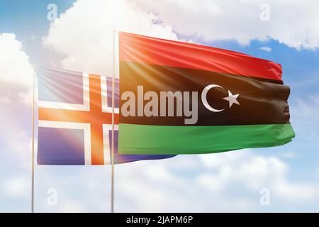 Sunny blue sky and flags of libya and iceland Stock Photo