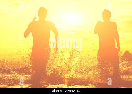 Group of young people playing games on sandy beach on a summer day. Stock Photo