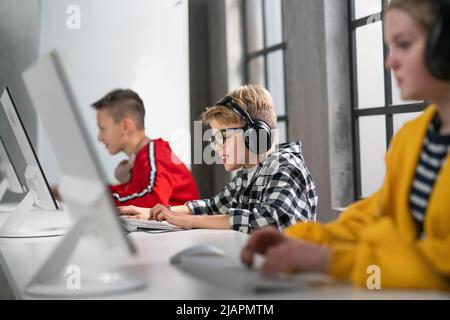 School kids using computer in classroom at school Stock Photo