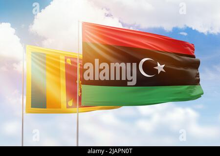 Sunny blue sky and flags of libya and sri lanka Stock Photo