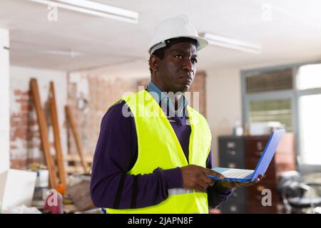 Portrait of man builder with laptop Stock Photo