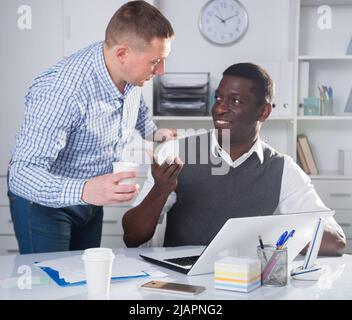 Smiling business partners working in office Stock Photo