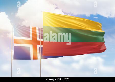 Sunny blue sky and flags of lithuania and iceland Stock Photo