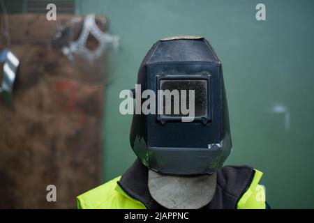 Unrecognizable man welder with helmet working in industrial factory. Stock Photo