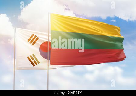 Sunny blue sky and flags of lithuania and south korea Stock Photo